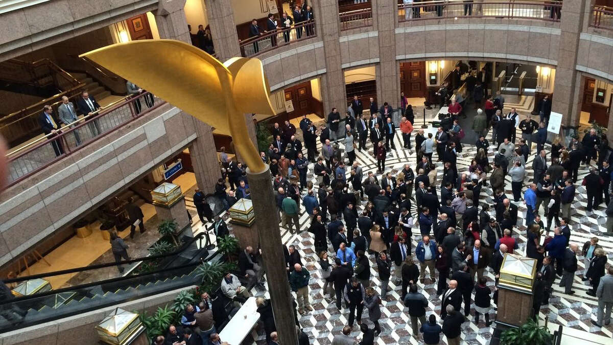 Package store owners and their supporters jammed into the Legislative Office Building's atrium prior to a public hearing to discuss Gov. Dannel P. Malloy's plan to eliminate the minimum pricing system at the state's package stores, in Hartford, Conn. Feb. 23, 2016. Many store owners strongly oppose the plan.