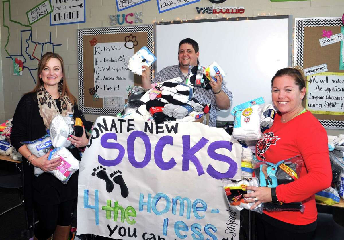 Salyards Middle School teacher Angie Buck, left, organized a sock donation drive to benefit Cypress-area charities. Other sponsors of the drive were Doug Harbrueger and Kristin Forrest.