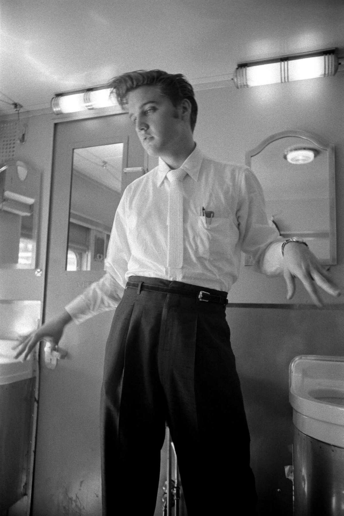 Elvis Presley shaking his hands dry following a wash on a train from New York City to Memphis, Tennessee, in July 1956. The image is found in the exhibition "Elvis at 21: Photographs by Arthur Wertheimer" at the National Portrait Gallery in Washington, D.C., through January 23. (National Portrait Gallery/MCT)