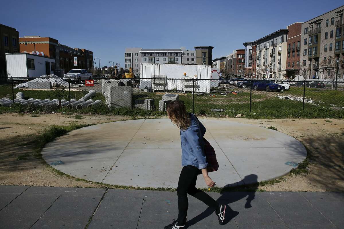 A woman walks past the site of a proposed hotel across from the Fox Theater and the Uptown Apartments Feb. 23, 2016 in Oakland, Calif. the site of a proposed hotel across from the Fox Theater and the Uptown Apartments Feb. 23, 2016 in Oakland, Calif.