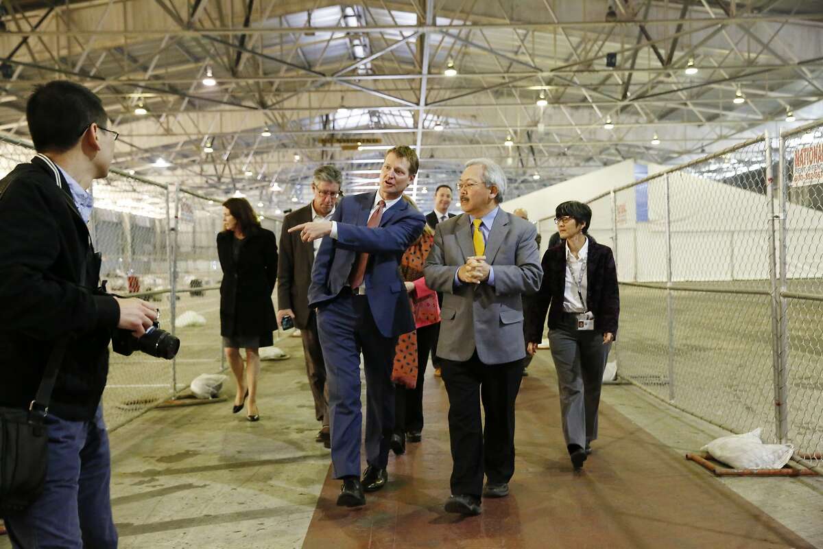 Trent Rhorer (l to r), executive director Human Services Agency, talks with Mayor Ed Lee as he takes him on a tour of the shelter at Pier 80 on Tuesday, February 23, 2016 in San Francisco, California.