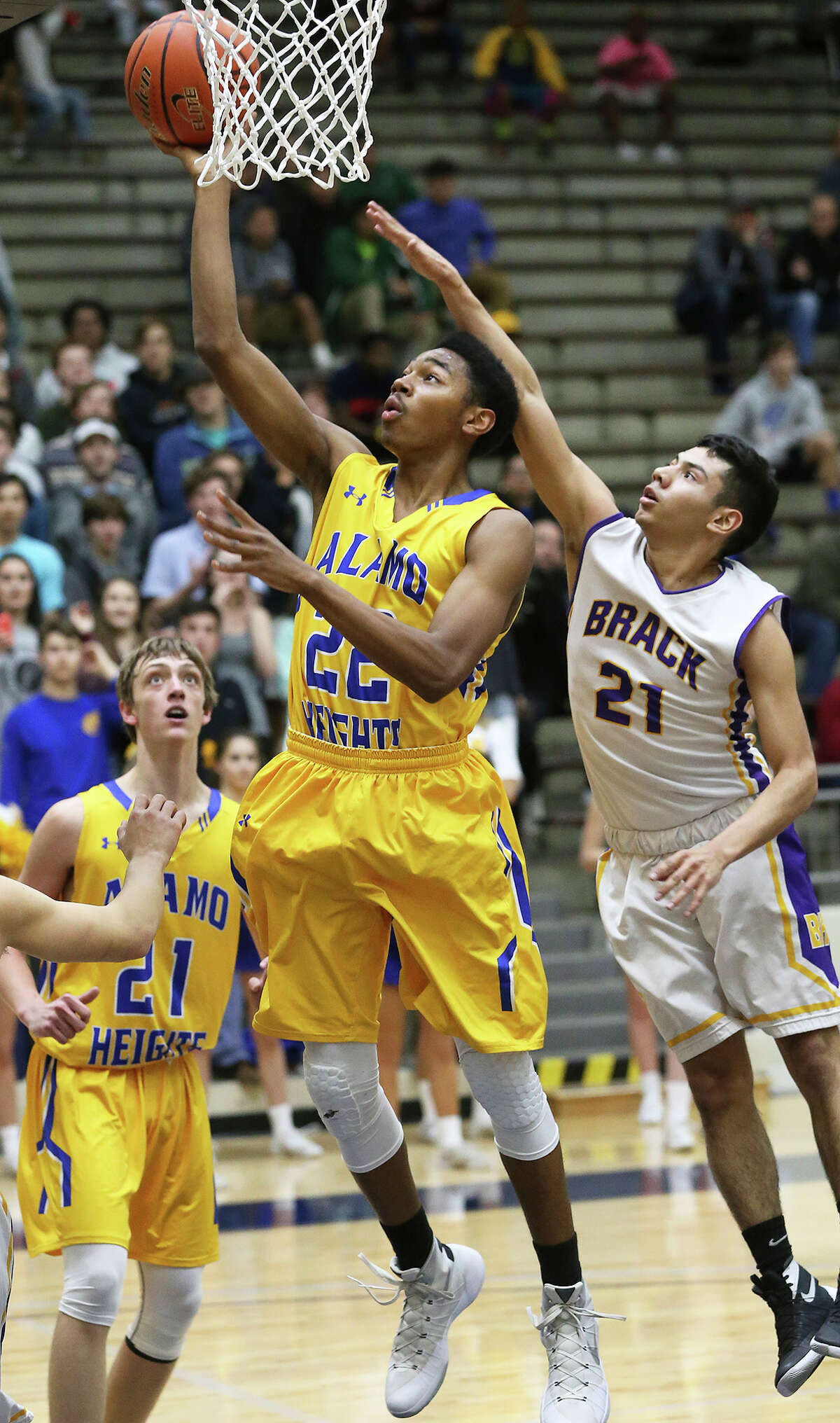 Mule guard Jonathan Dunn gets past Nathan Avila to score as Alamo Heights plays Brackenridge in 5A bidistrict basketball at the Alamo Convocation Center on February 23, 2016.