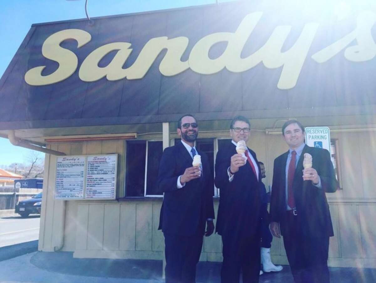 Rick Perry (middle) visits Sandy's Hamburgers in Austin after an appeals court dismissed abuse-of-power charges against him on Feb. 24, 2016.