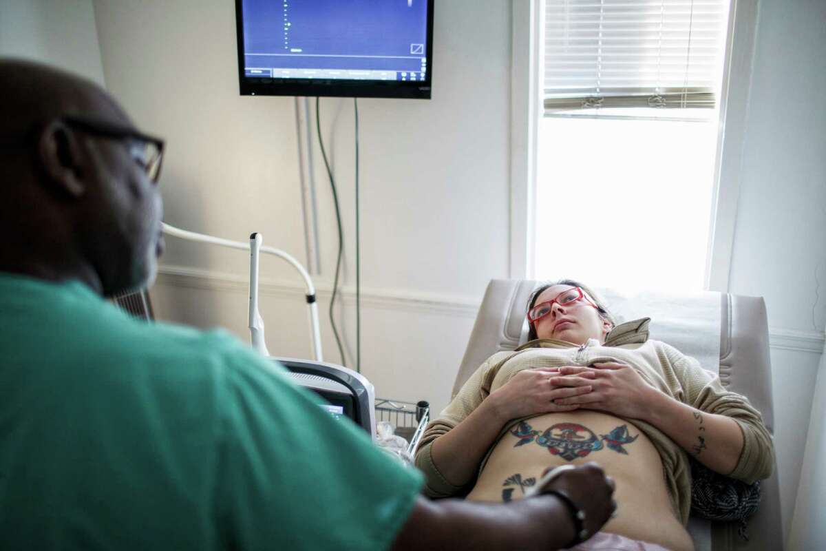 Dr. Willie Parker performs an ultrasound on Ashley Garza prior to her abortion at Reproductive Health Services in Montgomery, Ala., earlier this month. Parker travels between three different clinics.
