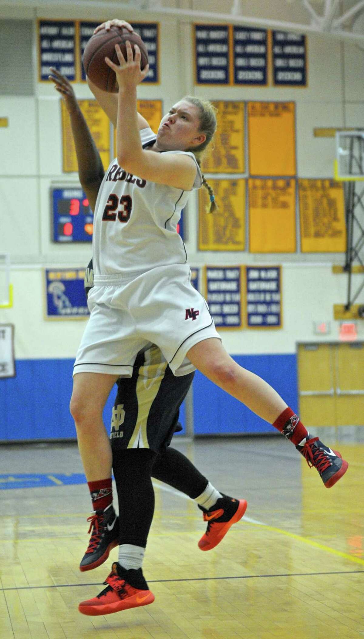 New Fairfield's Kristen Teklits (23) grabs a rebound from Notre Dame-Fairfield's Precious Montgomery in the SWC girls high school championship game between Notre Dame-Fairfield and New Fairfield high school, on Wednesday night, February 24, 2016, at New Town High School, Newtown, Conn.