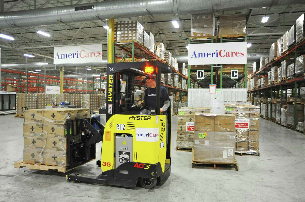 AmeriCares employee Donn Malner moves boxes of gauze pads, which will be shipped along with dozens of other critical supplies to Fiji, inside the AmeriCares warehouse.
