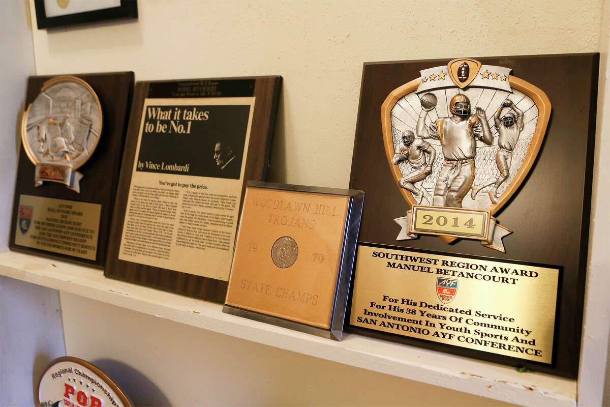 A sampling of the memorabilia and awards Manuel Betancourt has collected from coaching youth sports in San Antonio. Betancourt, who has coached locally since 1967, was recently inducted into the American Youth Football Hall of Fame. MARVIN PFEIFFER/ mpfeiffer@express-news.net