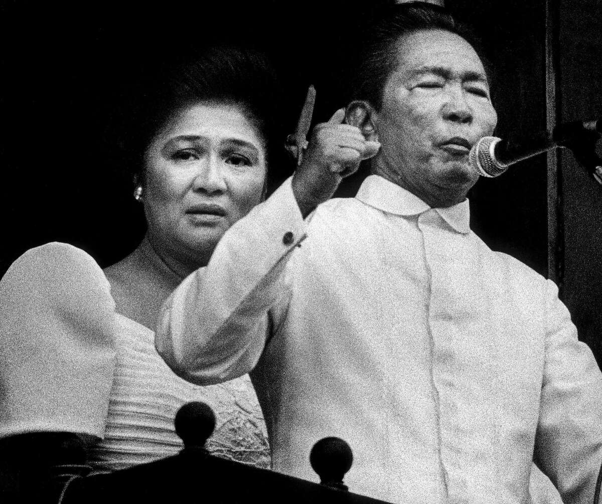 Ferdinand Marcos addresses a crowd of supporters from the balcony of the presidential palace. His wife, Imelda Marcos, is on the verge of tears. A few hours later, they fled the Philippines. (Feb. 25, 1986.) Photo by Kim Komenich for the San Francisco Examiner. (Copyright, 2011, Bancroft Library/the University of California)