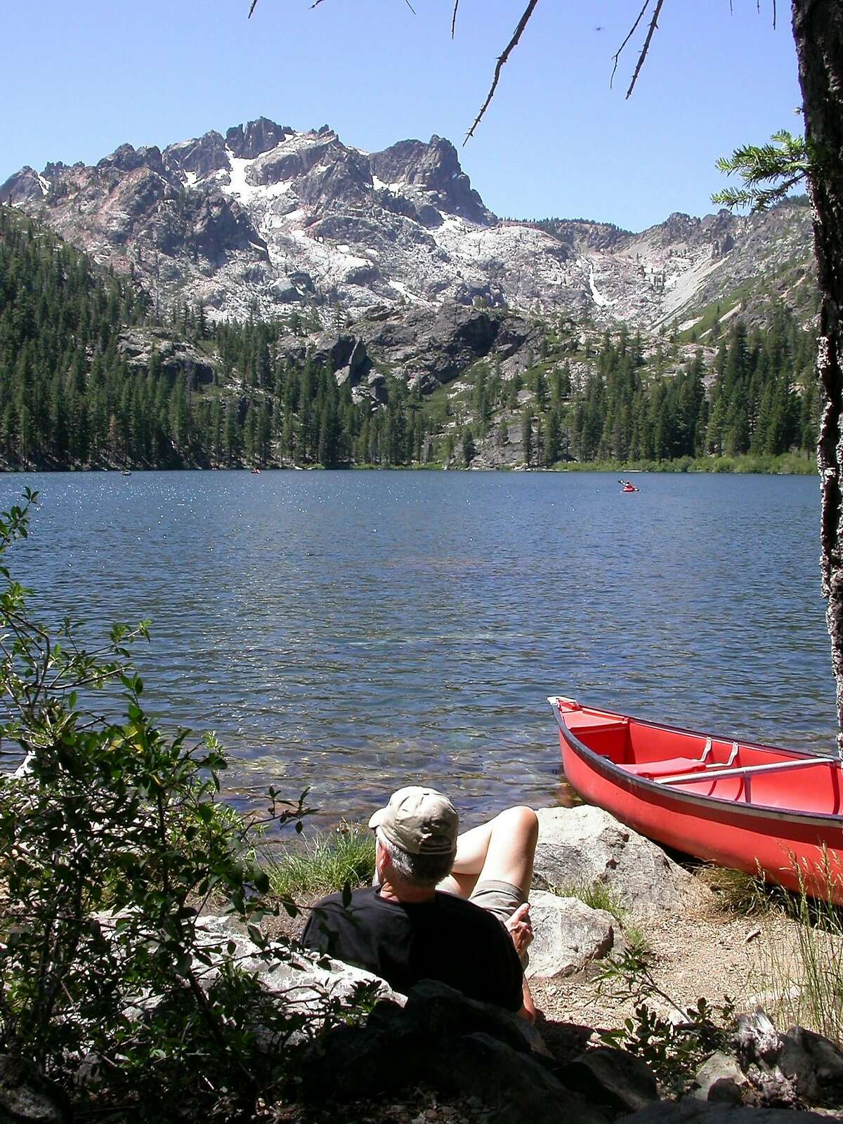 The Sierra Buttes loom over Lower Sardine Lake, where visitors can canoe, kayak, putt around in a small boat or just gaze at the scenery.