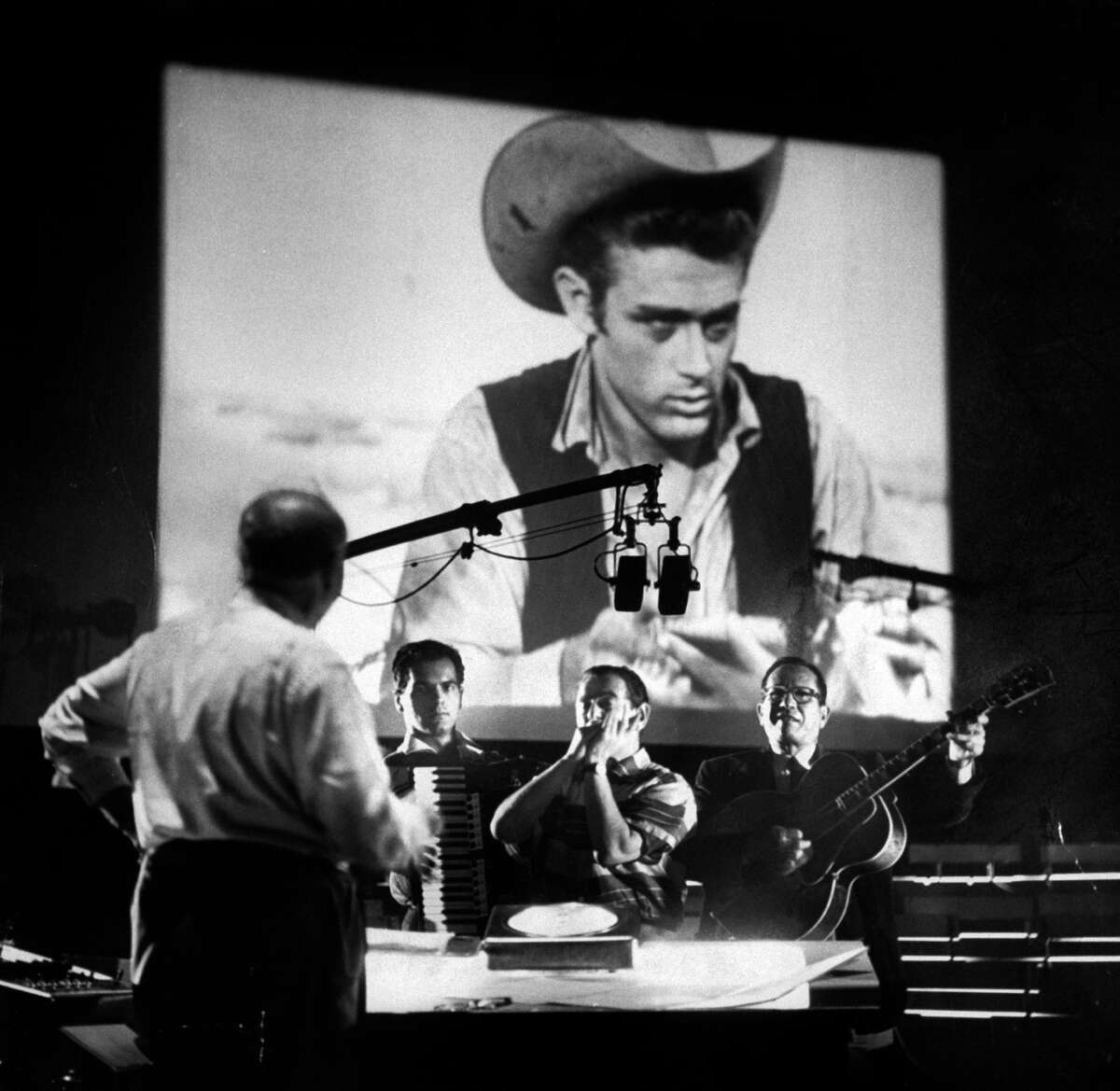 Photos of the 1956 film "Giant" and late actor James Dean Composer Dimitri Tiomkin (L) directing the muscial score for the last James Dean movie produced 'Giant'.