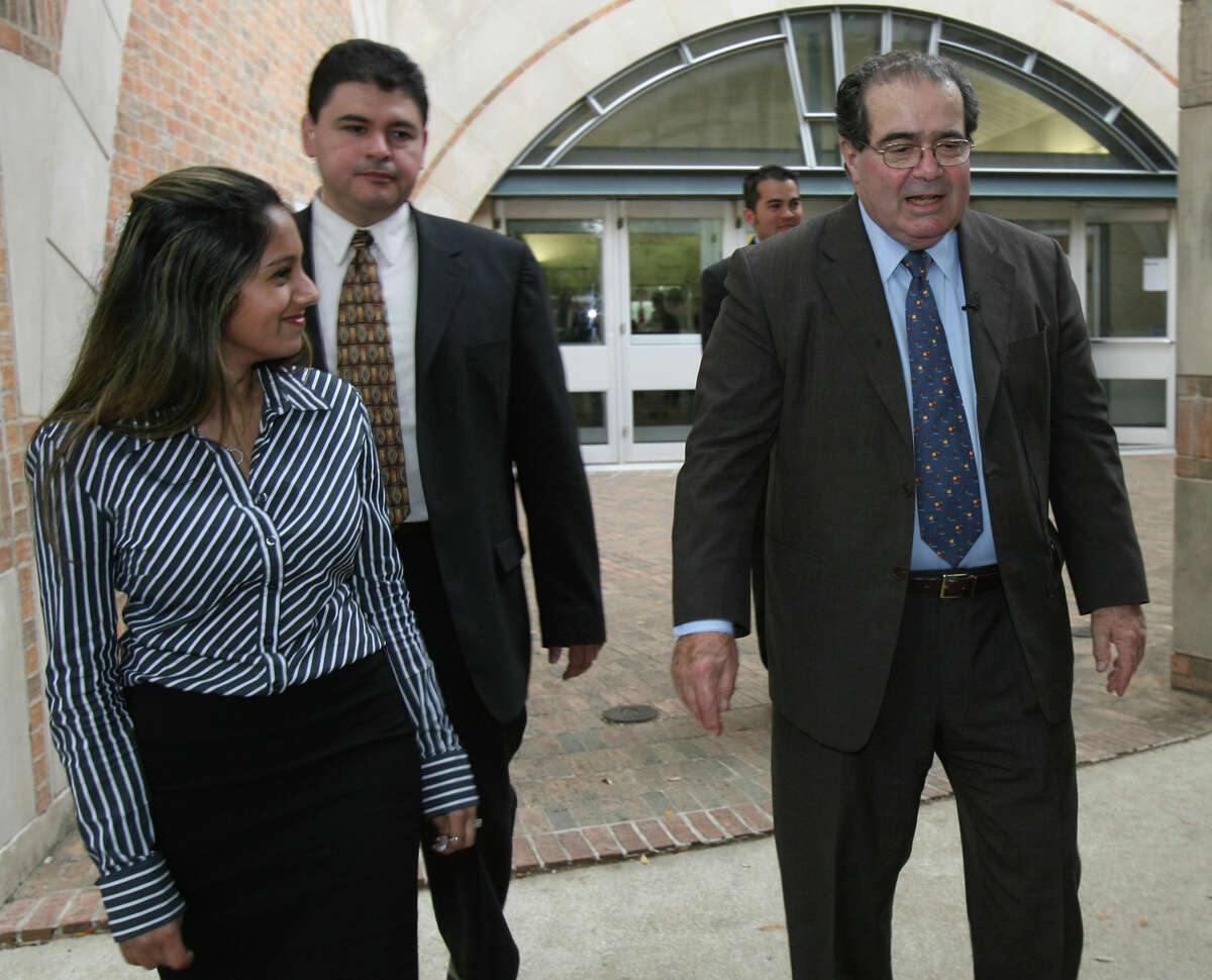 U.S. Supreme Court Associate Justice Antonin Scalia (rt.) leaves a luncheon at St. Mary's University on Thursday April 3, 2008. On the left is first year law student Nishma Shah, who thanked Scalia for speaking to the Constitutional law class that she was a student in.
