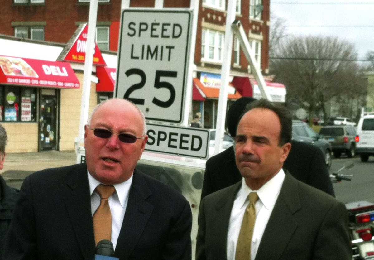 Police Captain Armando "A.J." Perez and Mayor Joseph Ganim stand by a portable machine that registers vehicle speed on State Street Thursday. Police are trying to improve traffic safety following three pedestrian fatalities.
