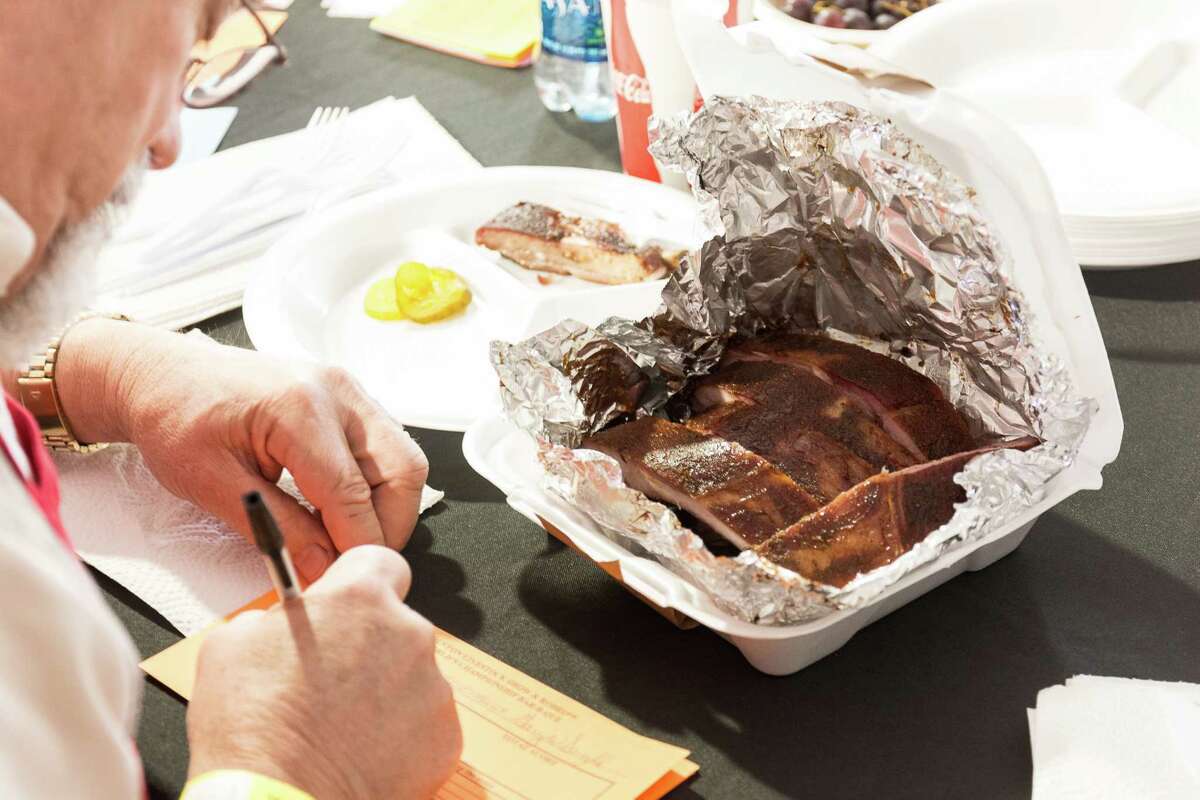 A cook-off judge scores a barbecue sample at the World's Championship Bar-B-Que competition at the Houston Livestock Show and Rodeo in 2015.