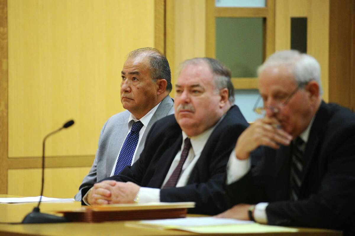 Businessman Miguel Juarez, left, sits with attorneys Martin Minella, center, and Robert Bello as he awaits sentencing Thursday in state Superior Court in Stamford. Juarez will remain free for at least a year before reporting to jail for his eight-year sentence.