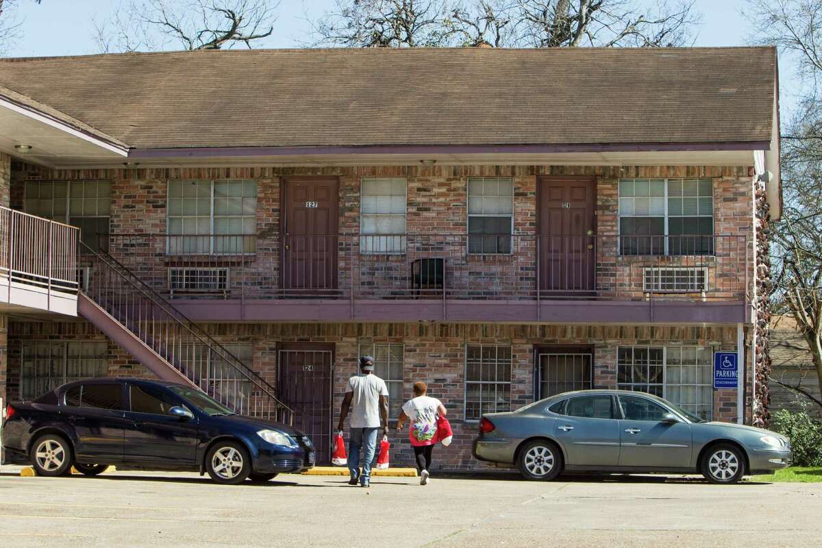 People walk with bags of groceries to an apartment near the intersection of Yellowstone and Sherwood in the Third Ward on Thursday, Feb. 18, 2016, in Houston. Harris County officials are seeking an injuction to prevent nearly 100 suspected gang members from entering the two-square-mile Southlawn community in south Houston. ( Brett Coomer / Houston Chronicle )