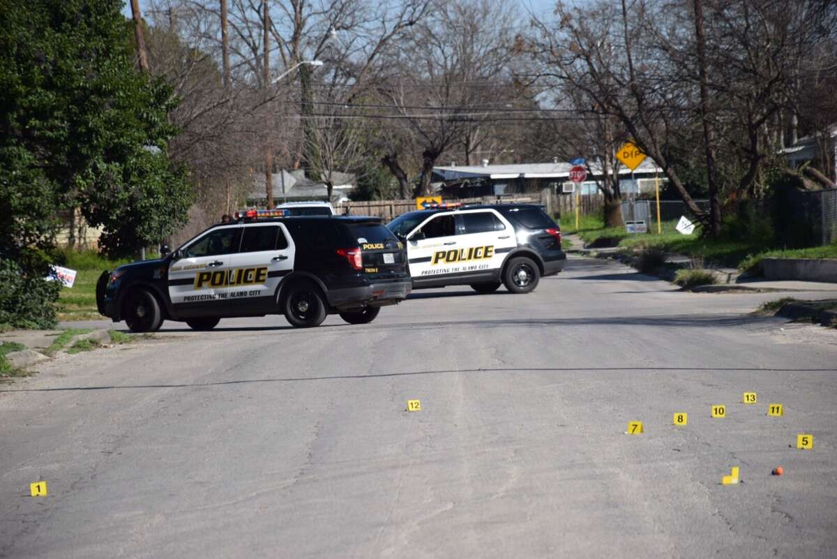 San Antonio Police Department investigators scour a shooting scene in the 300 block of Corliss Avenue on Feb. 26, 2016 after a group of gunmen opened fire into a crowd of people, injuring one.