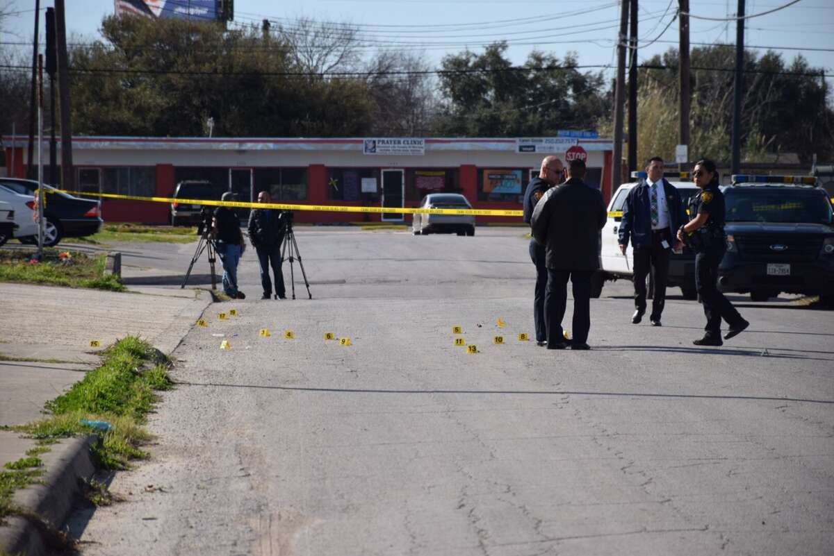 San Antonio Police Department investigators scour a shooting scene in the 300 block of Corliss Avenue on Feb. 26, 2016 after a group of gunmen opened fire into a crowd of people, injuring one.