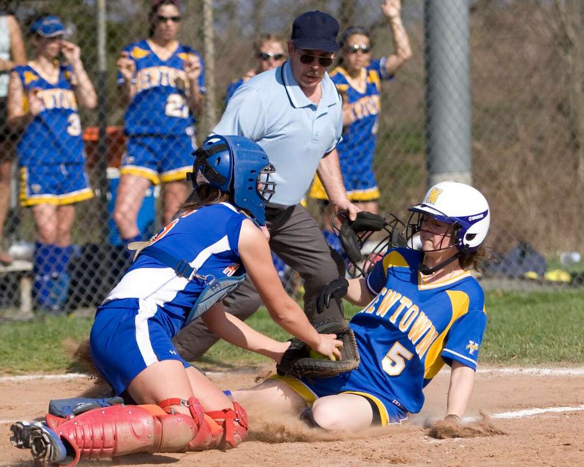 Danbury catcher Lindsay Trohalis tags out Newtown's Monica Macchiarulo at the plate. Macchiarulo tried to score on a fly ball but was gunned out by Hatters centerfielder Erica Carboni Wednesday at Danbury High.