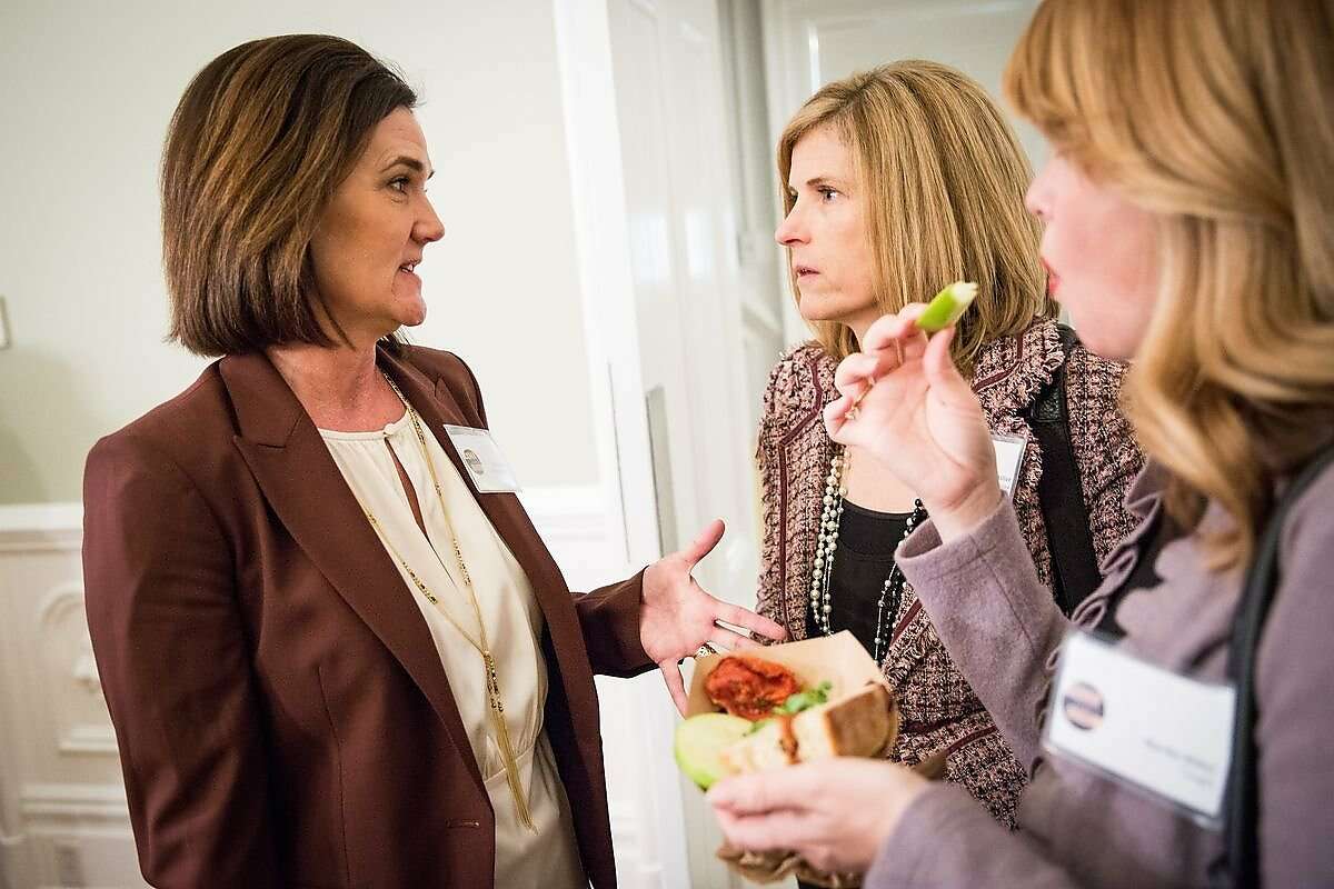 Political Solutions co-founders Stacy Dwelley, left, and Tami Miller, center, at a recent Sacramento event. Politicians, lobbyists and journalists mingle at a #WinLikeAGirl reception at the Governor's Mansion in Sacramento, California, February 11, 2016.
