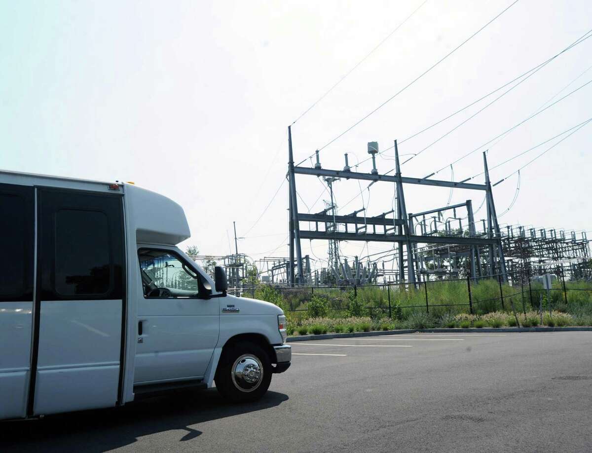 The Connecticut Siting Council tour bus passes by the Cos Cob substation in the Cos Cob section of Greenwich, Conn., Tuesday, Sept. 1, 2015.