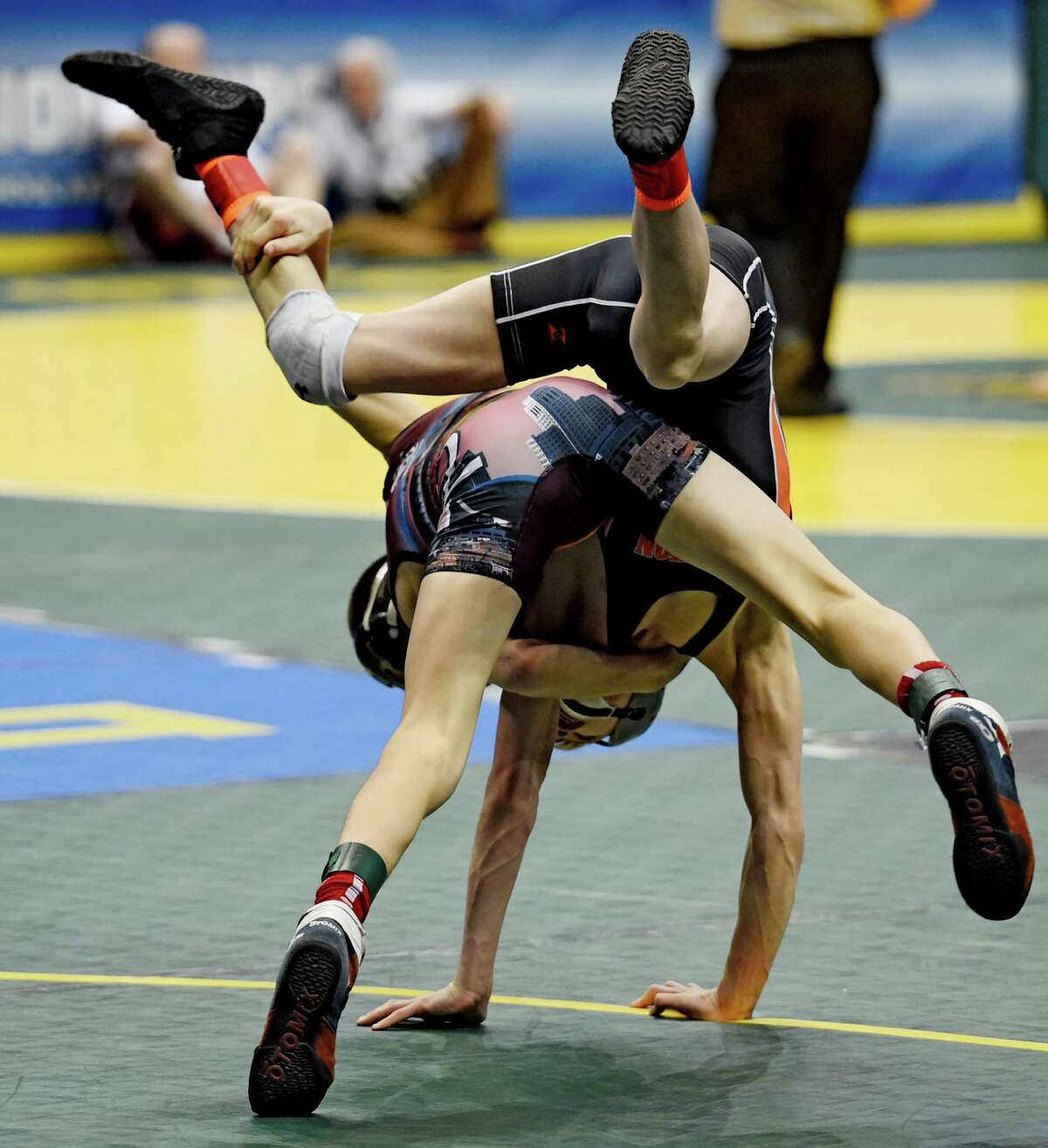 Matt Leporte of Hoosick Falls flips Dalton Gardner of Fredonia by Trent Svingala of Albany Academy, top during the 99 lb. preliminaries at the NYSPHSAA State Championship Wrestling competition held at the Times Union Arena Friday Feb. 25, 2016 in Albany, N.Y. (Skip Dickstein/Times Union)
