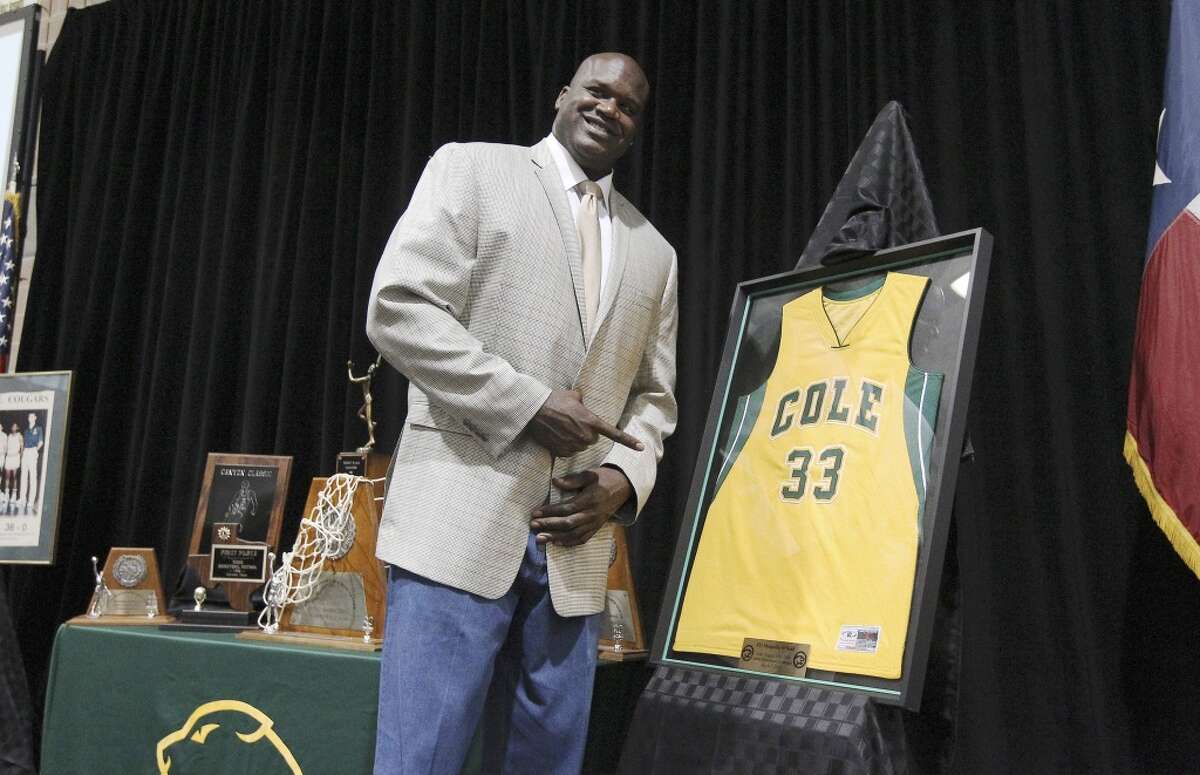 Shaquille O'Neal, Cole High School Retired basketball star Shaquille O'Neal poses with a jersey representing his school and number during his high school jersey retirement ceremony at Cole High School on Friday, mar. 7, 2014. O'Neal graduated from Cole in 1989 and took the basketball team to a 3A State championship. (Kin Man Hui/San Antonio Express-News)