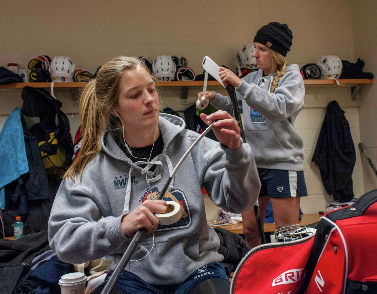 Kiira Dosdall of Fairfield, right, and Bray Ketchum of Greenwich tape their sticks in the New York Riveters’ locker room before their National Women's Hockey League game last month against the Connecticut Whale at Ingalls Rink at Yale University in New Haven.