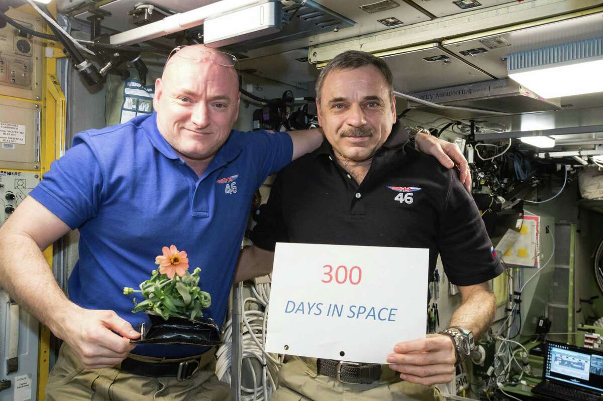 American astronaut Scott Kelly celebrates a milestone along with Russian cosmonaut Mikhail Kornienko. Scientists will take samples of body fluids to study the effects of spending nearly a year in space, looking to understand how the human body holds up during long stints in space, such as a potential three-year journey to Mars. ﻿