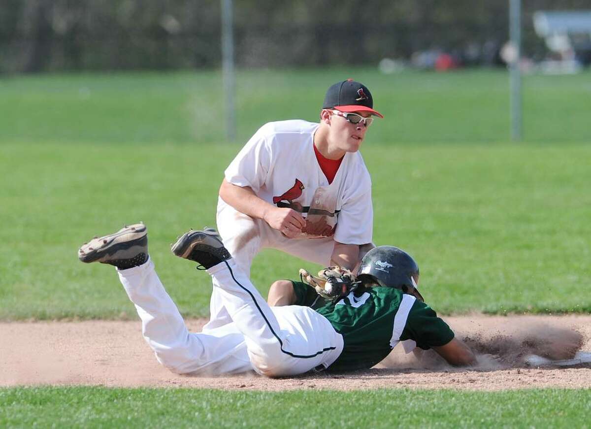 GHS shortstop, Michael Dunster, # 24, puts the tag on Chris Kassimis, # 9, of NHS during an unsuccessful pick-off during Greenwich High School vs. Norwalk High School game in which Greenwich High School won 4-1, April 7, 2010.