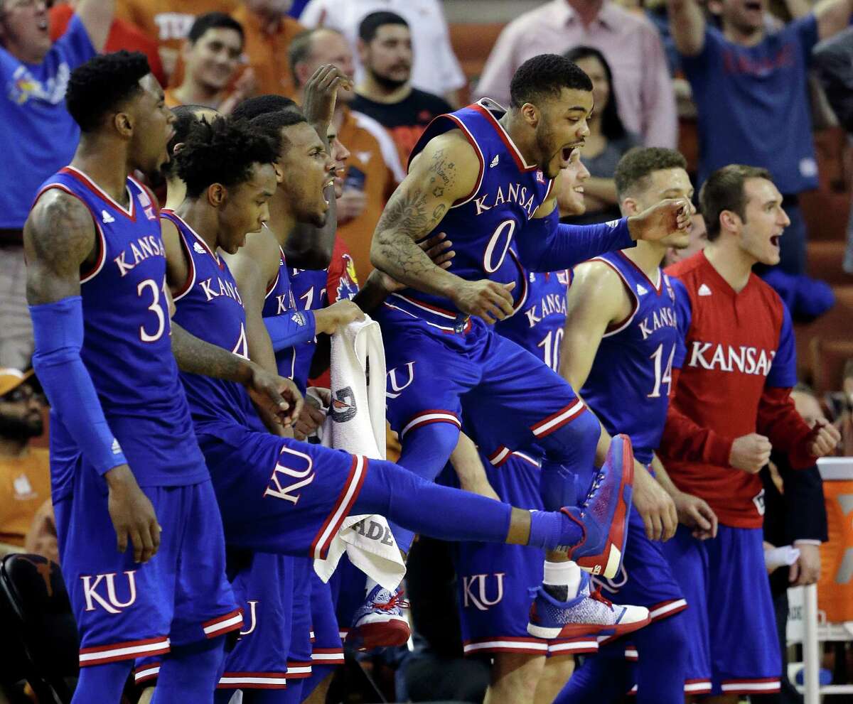 Kansas guard Frank Mason III (0) leaps in the air as he and teammates celebrate a score against Texas during the second half of an NCAA college basketball game, Monday, Feb. 29, 2016, in Austin, Texas. Kansas won 86-56. (AP Photo/Eric Gay)