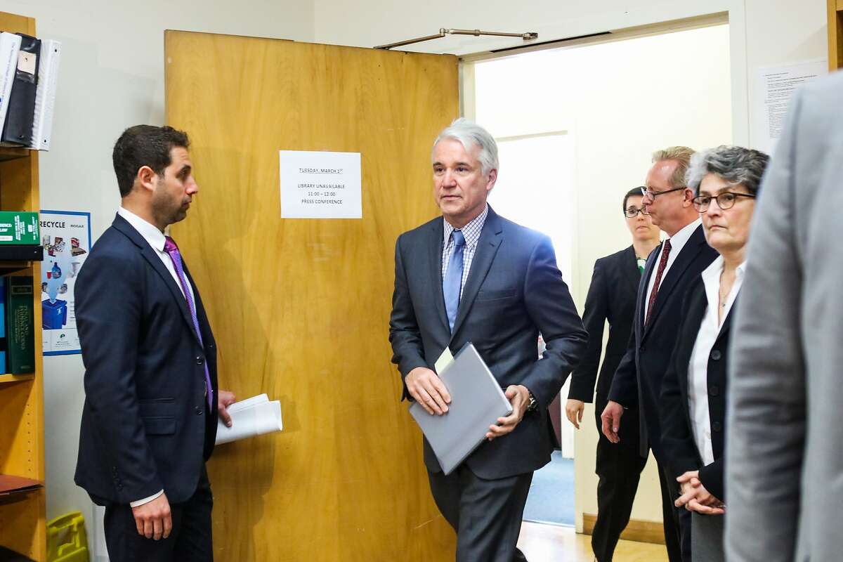 District Attorney George Gascon (center) makes his way to a press conference where he will announce the filing of a felony and misdemeanor charges against three former and one current deputy, in San Francisco, California, on Tuesday, March 1, 2016.