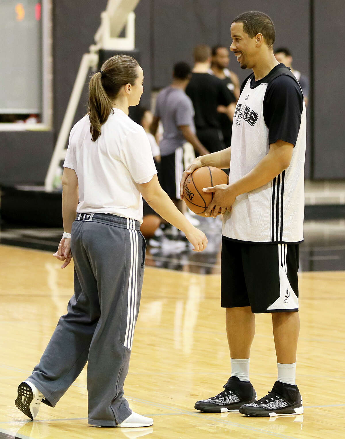 The newest Spurs roster addition, veteran guard Andre Miller, works with assistant coach Becky Hammon during his first workout at the Spurs practice facility on Tuesday, March 1, 2016.