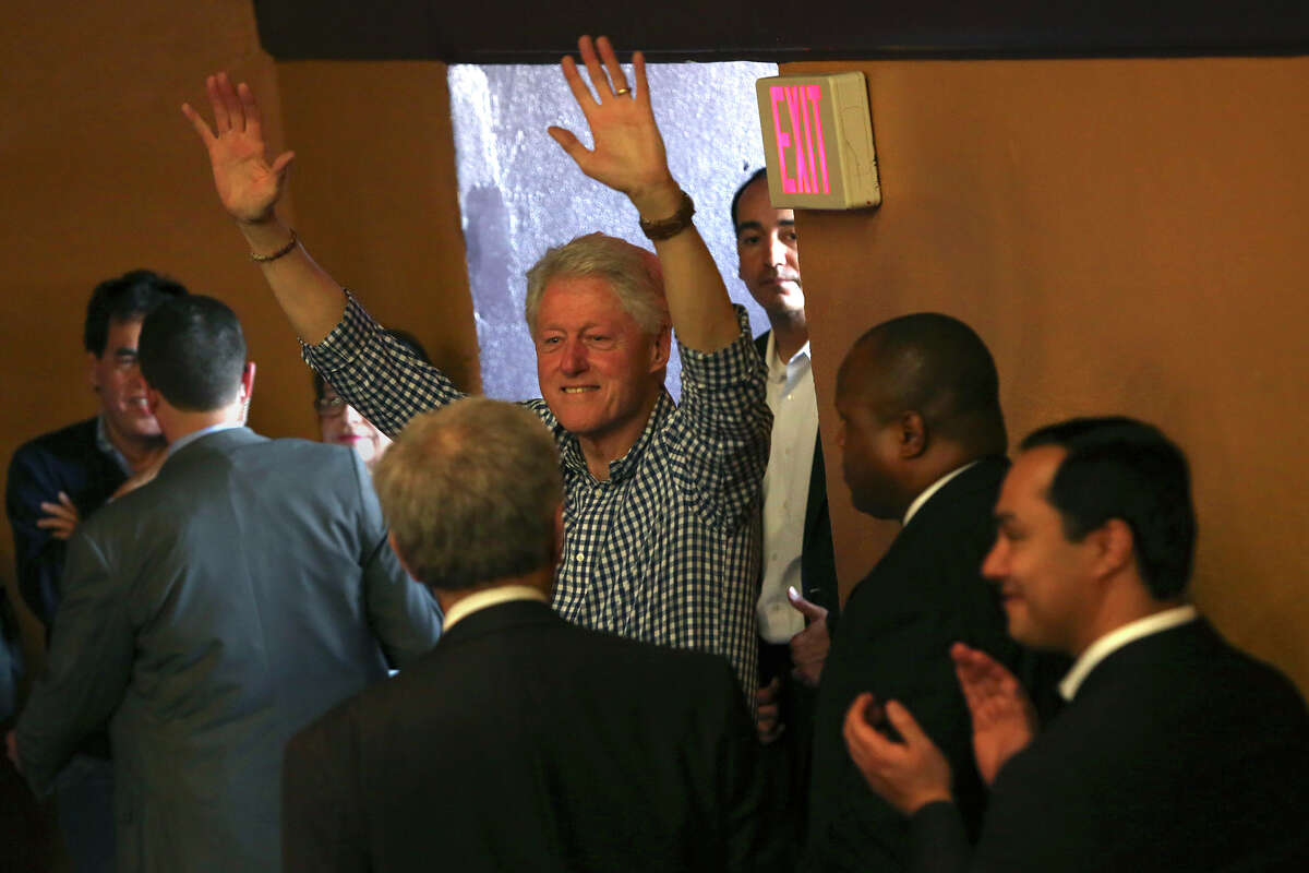 Former President Bill Clinton, followed by Congressman Joaquin Castro, far right, waves to supporters as they leave the Hillary for Texas Get Out The Vote Rally at the Guadalupe Cultural Arts Center Theater in San Antonio on Monday, Feb. 29, 2016.