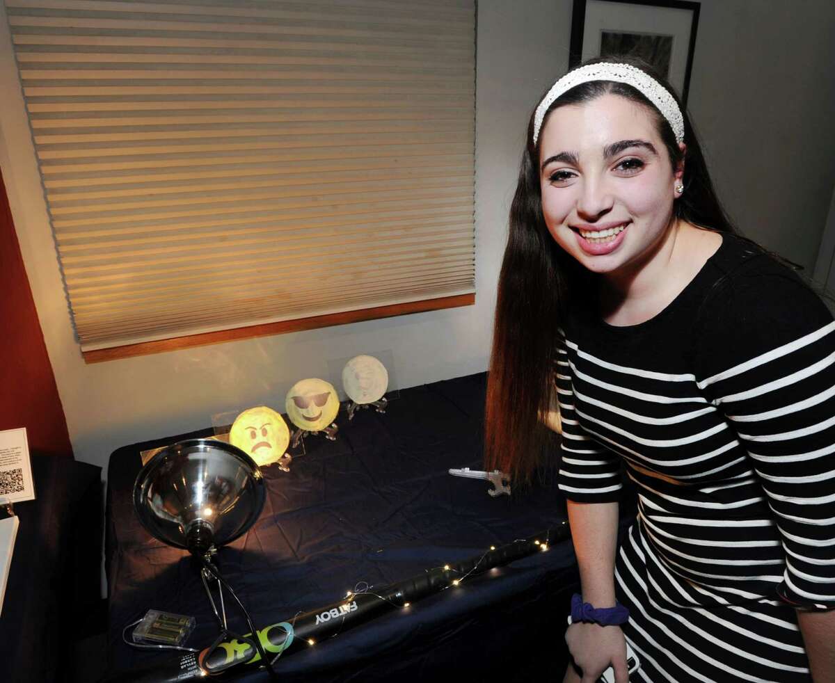 Greenwich High School sophomore Emily Gunzburg, 15, stands by the project she created using Thermochromic paint, a special paint that changes color due to a change in temperature, that was part of the exhibition of the Humanities and Modernism projects created by the Greenwich High School sophomores who are members of the Innovation Lab program at the Bruce Museum in Greenwich on Feb. 2.