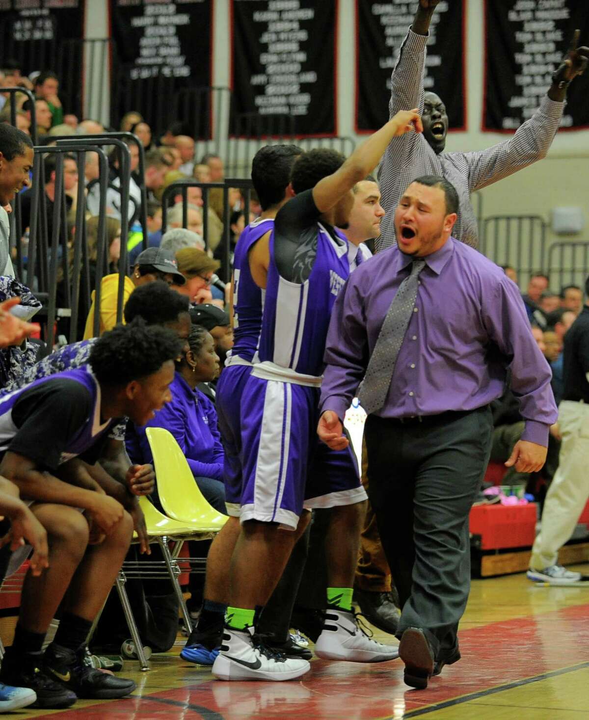 Westhill assistant coach Roberto Nieves celebrates the Vikings 53-43 win over Trumbull in an FCIAC boys basketball semifinal at Warde High School in Fairfield, Conn. on March 1, 2016. Nieves was filling in for Coach Howard White.