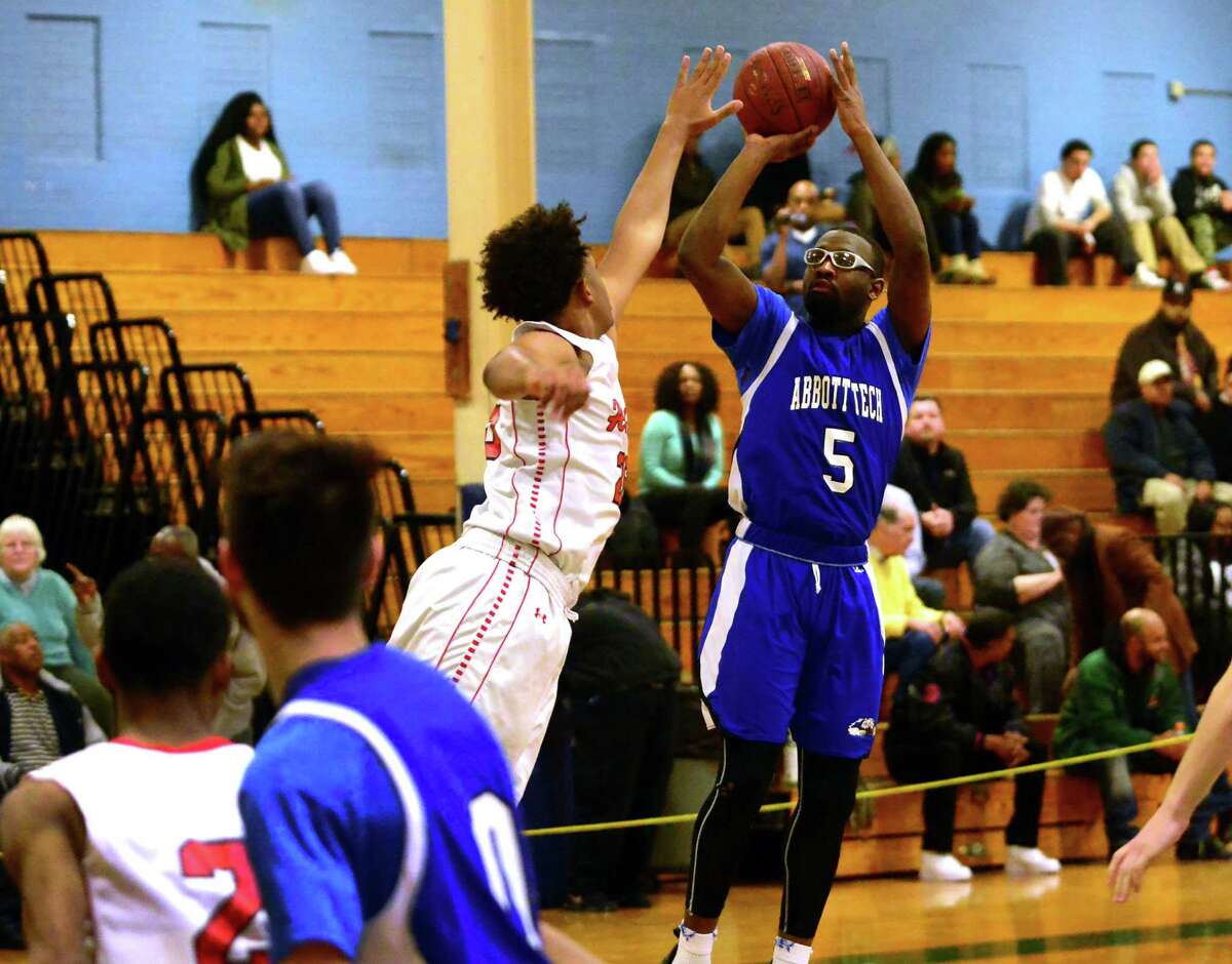 Abbott Tech’s Omari Johnson releases a shot as University's Justin Williams defends during their CSC semifinalgame Tuesday in Bridgeport.