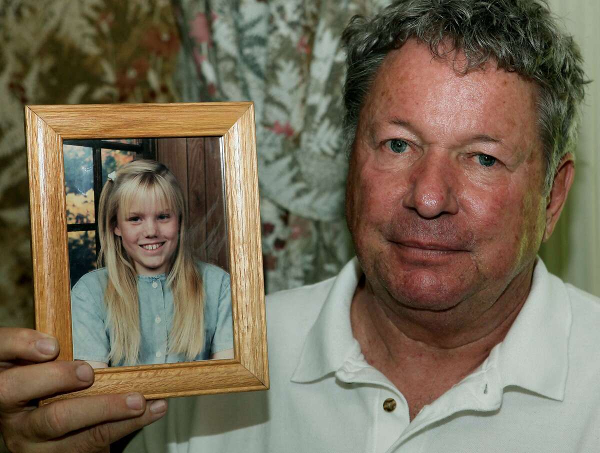 Carl Probyn, 60, stepfather of Jaycee Lee Dugard who went missing in 1991, holds photos of his stepdaughter at his home in Orange, Calif., Thursday, Aug. 27, 2009. (AP Photo/Nick Ut)