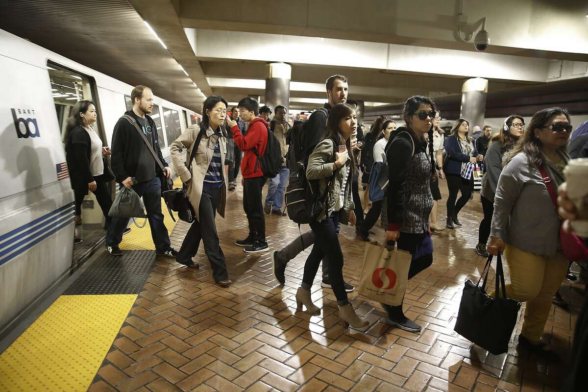 Commuters get off the train at the Montgomery BART station during the morning commute in San Francisco, California, on monday, february 29, 2016. BART will be testing offering incentives for commuters riding outside during the busiest time of the morning.