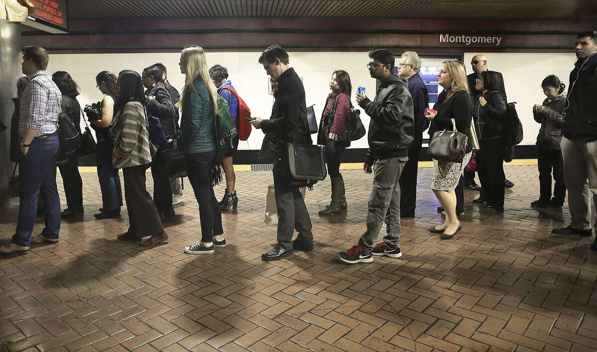 Commuters wait for the escalator at the Montgomery BART station during the morning commute in San Francisco, California, on monday, february 29, 2016. BART will be testing offering incentives for commuters riding outside during the busiest time of the morning.