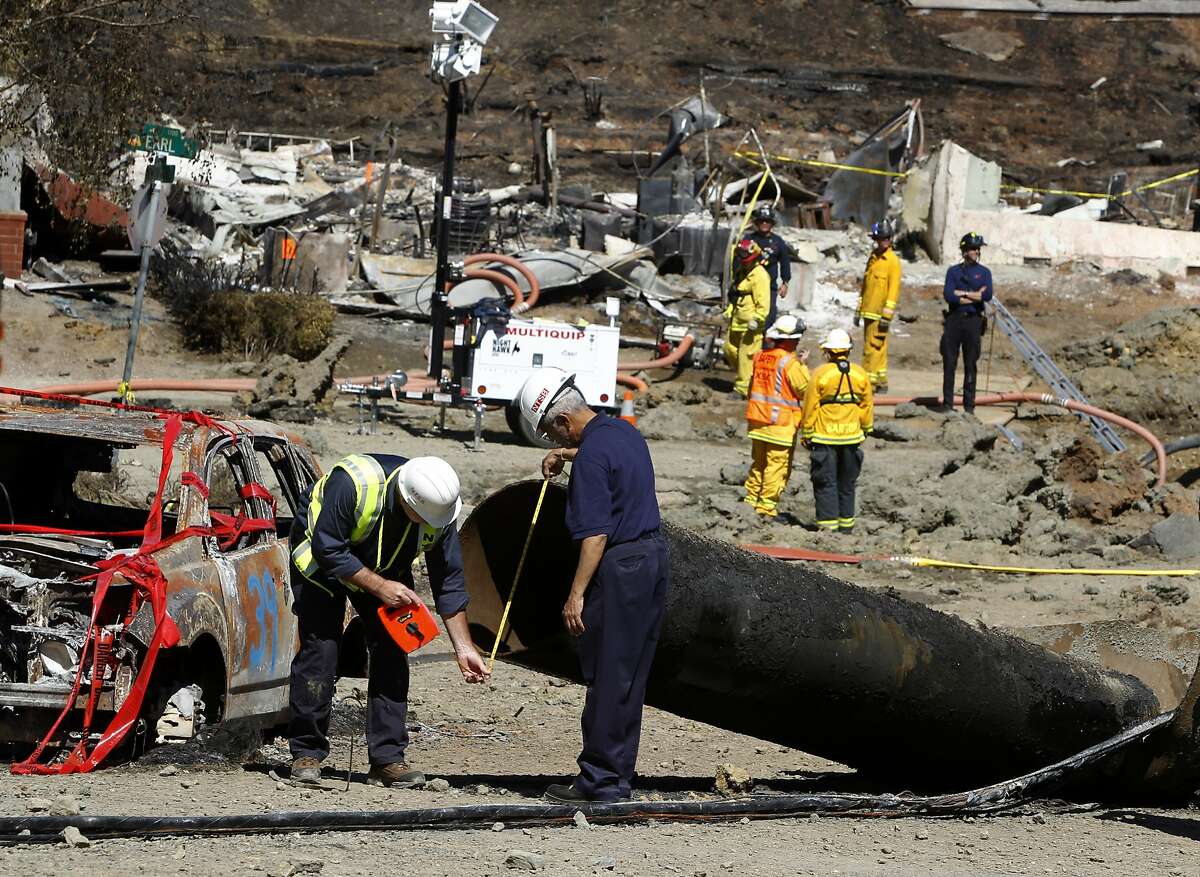 Federal investigators inspect a 40-foot section of pipeline on Glenview Drive in San Bruno on Saturday.