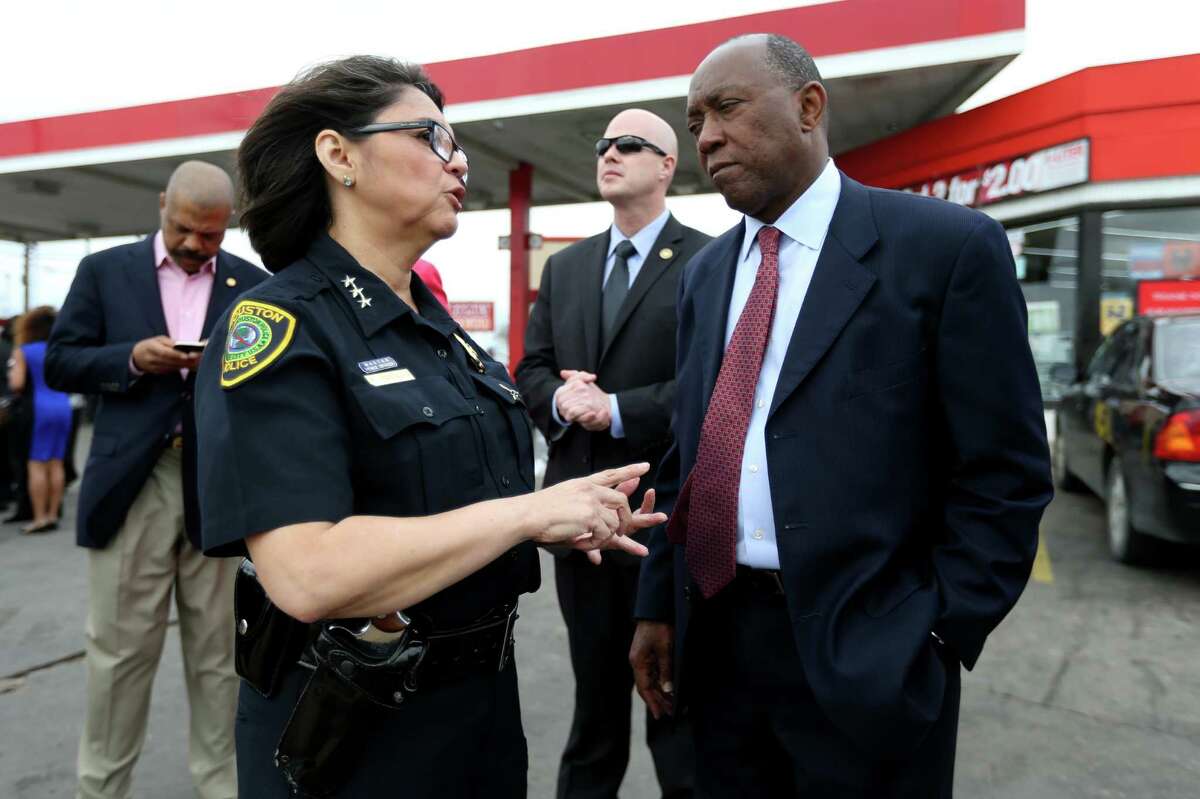 Interim Houston Police Chief Martha Montalvo and Mayor Sylvester Turner take time to talk after Turner made a plea for an end to the bloodshed during a news conference held at Time Rise Mart located at the corner of Cullen and Bellfort on Wednesday.