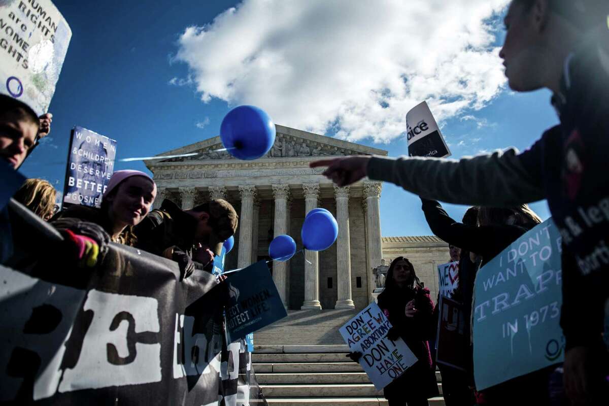Anti-abortion and pro-abortion rights demonstrators rally outside the U.S. Supreme Court.﻿