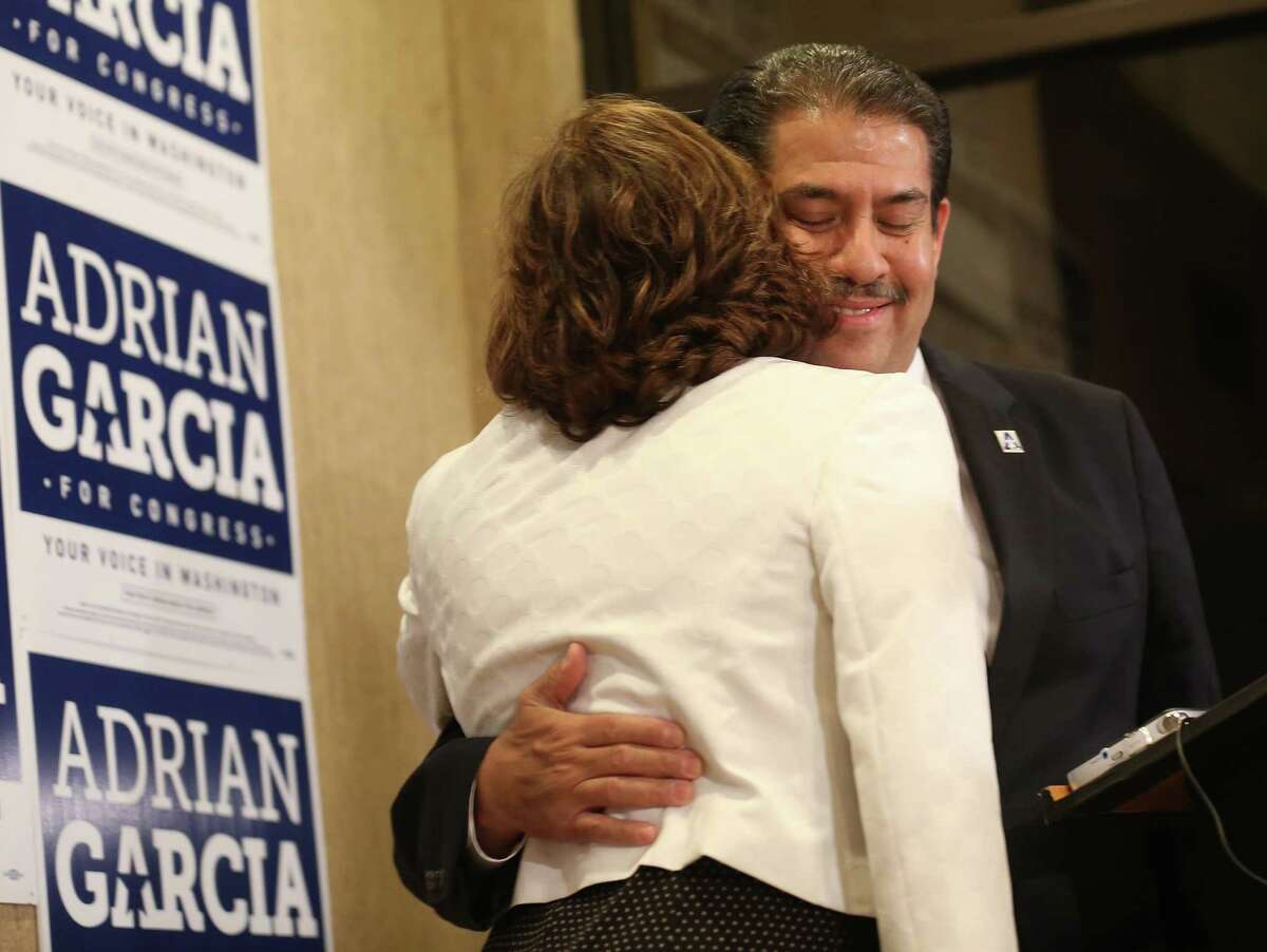 Primary congressmen candidate Adrian Garcia hugs his wife, Monica, before talking to his supporters at his headquarters after losing the democratic congressional primary on Tuesday, March 1, 2016, in Houston.