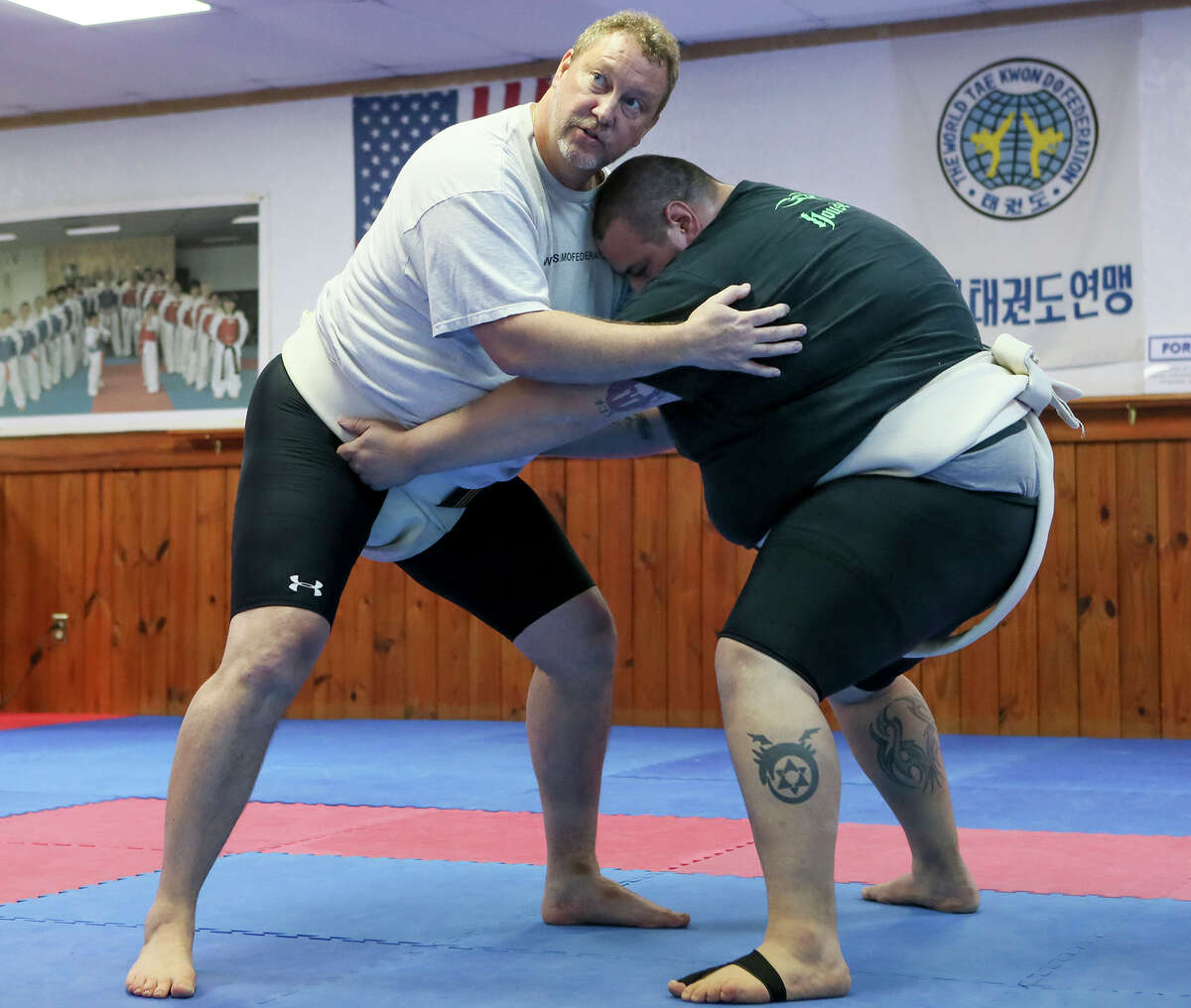 Tom Zabel (left) teaches sumo techniques with Frank Pena during a Lone Star Sumo Association practice session at the Korea-America Taekwondo Academy, 9585 Braun Rd, on Tuesday, Feb. 24, 2016. MARVIN PFEIFFER/ mpfeiffer@express-news.net
