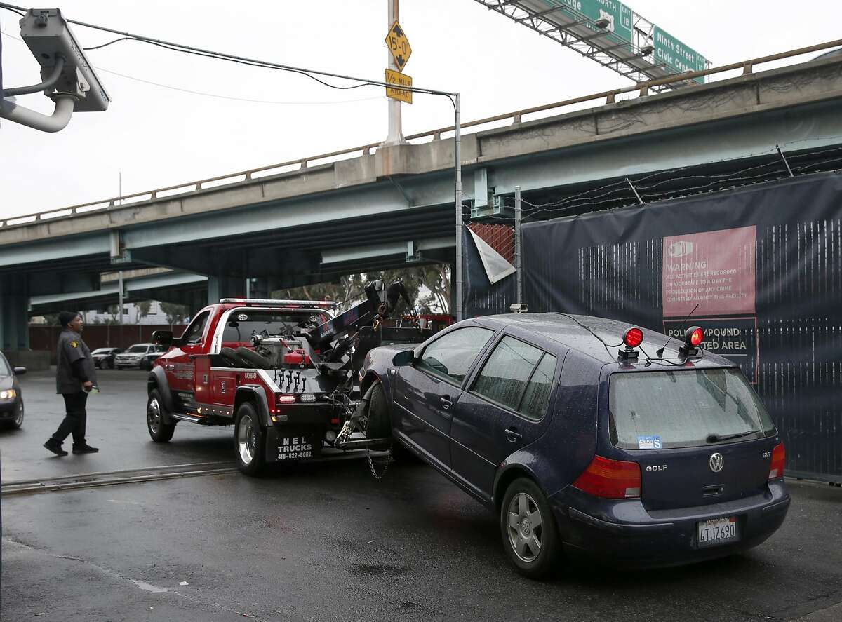 A tow truck with a car hooked to it arrives at the authorized vehicle impound lot in San Francisco, Calif. on Thursday, March 3, 2016. San Francisco has among the highest towing fees in the nation, typically running around $500 not including the cost of the parking violation.