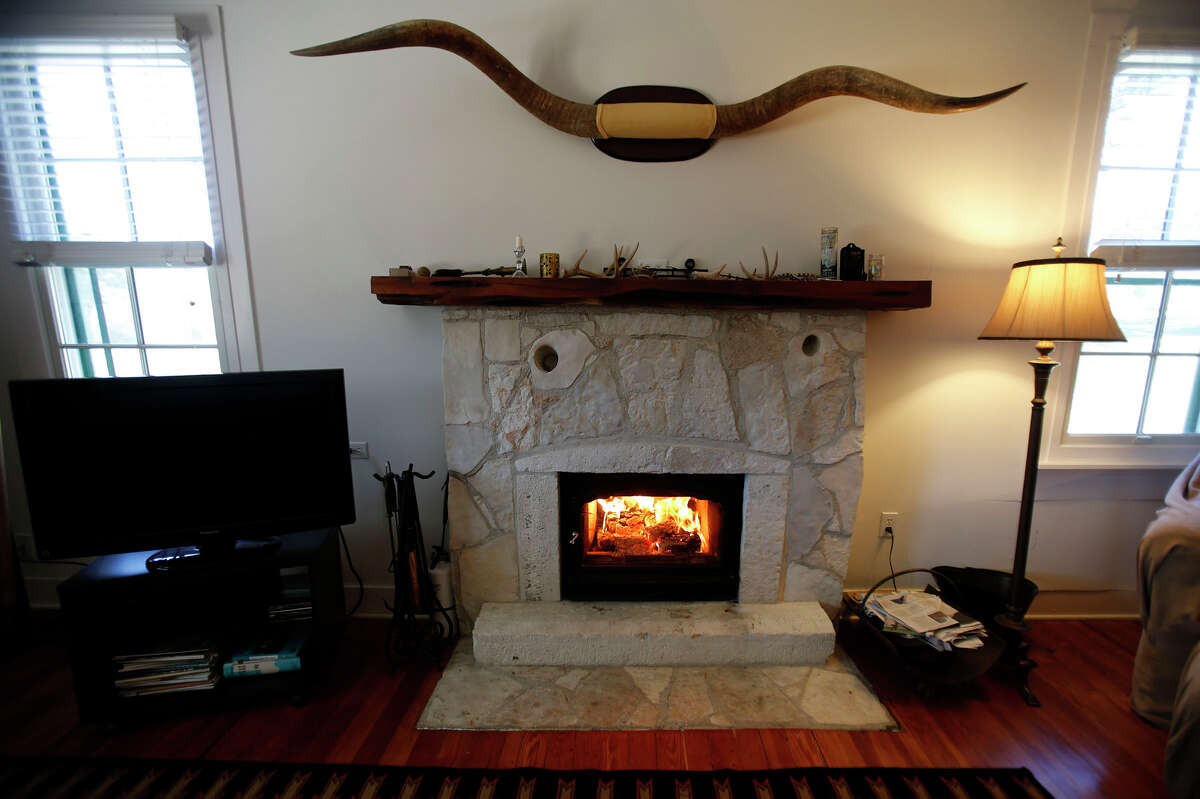 A seven-foot longhorn spread, from the last feral longhorn on the Dobie Paisano Ranch west of Austin, adorns the wall over the fireplace in the ranch house living room.