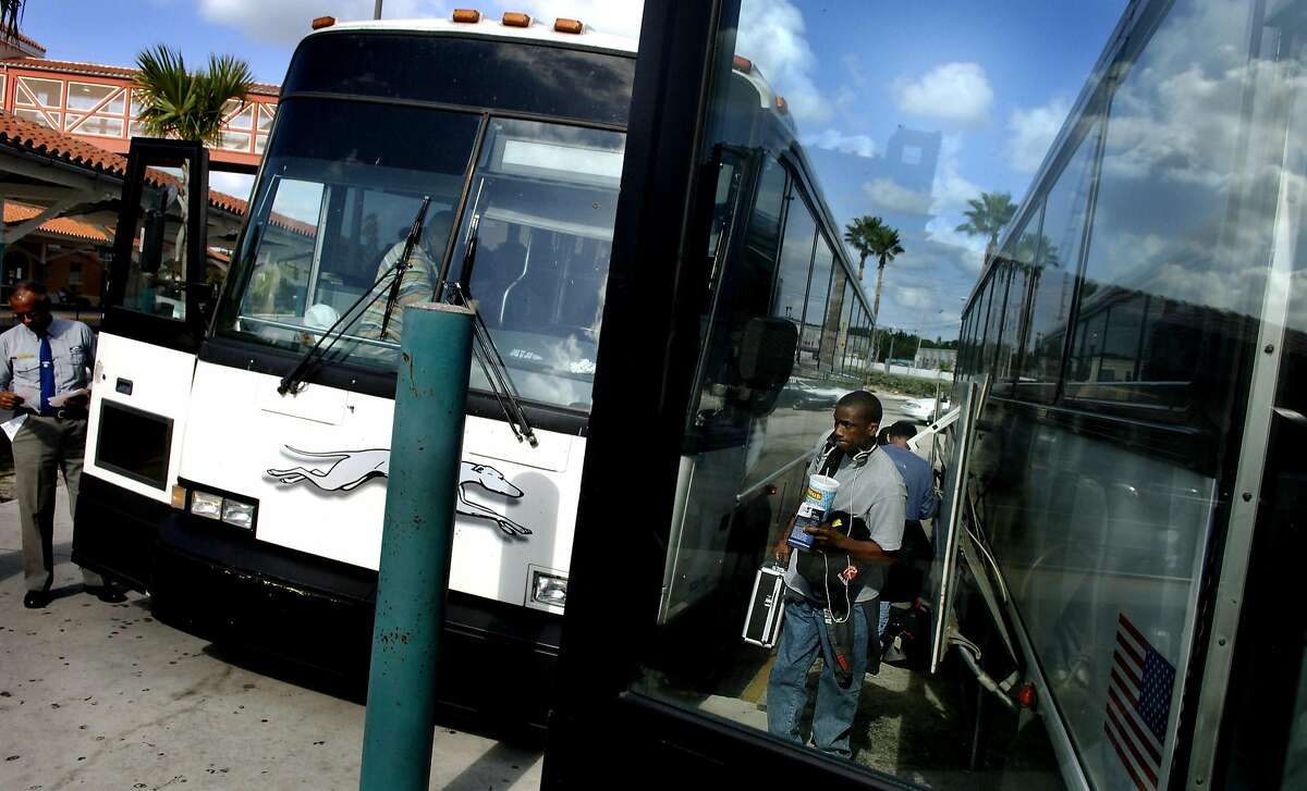 PGREYHOUND18A -- Max Ley (cq), 18, gathers his belongings after exiting a Greyhound bus at the West Palm Beach station Monday afternoon. Ley was traveling from Georgia to visit family in Boynton Beach for the holidays. Staff Photo/John L. White