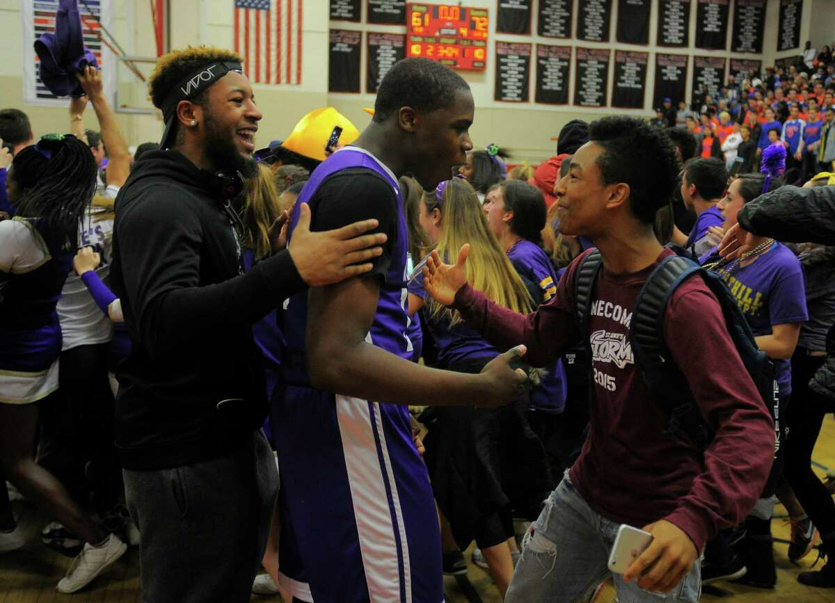Westhill Tyrell Alexander celebrates with fans. Westhill defeated Danbury 72-61 in an FCIAC basketball championship at Fairfield Warde High School in Fairfield, Conn. on March 3, 2016.