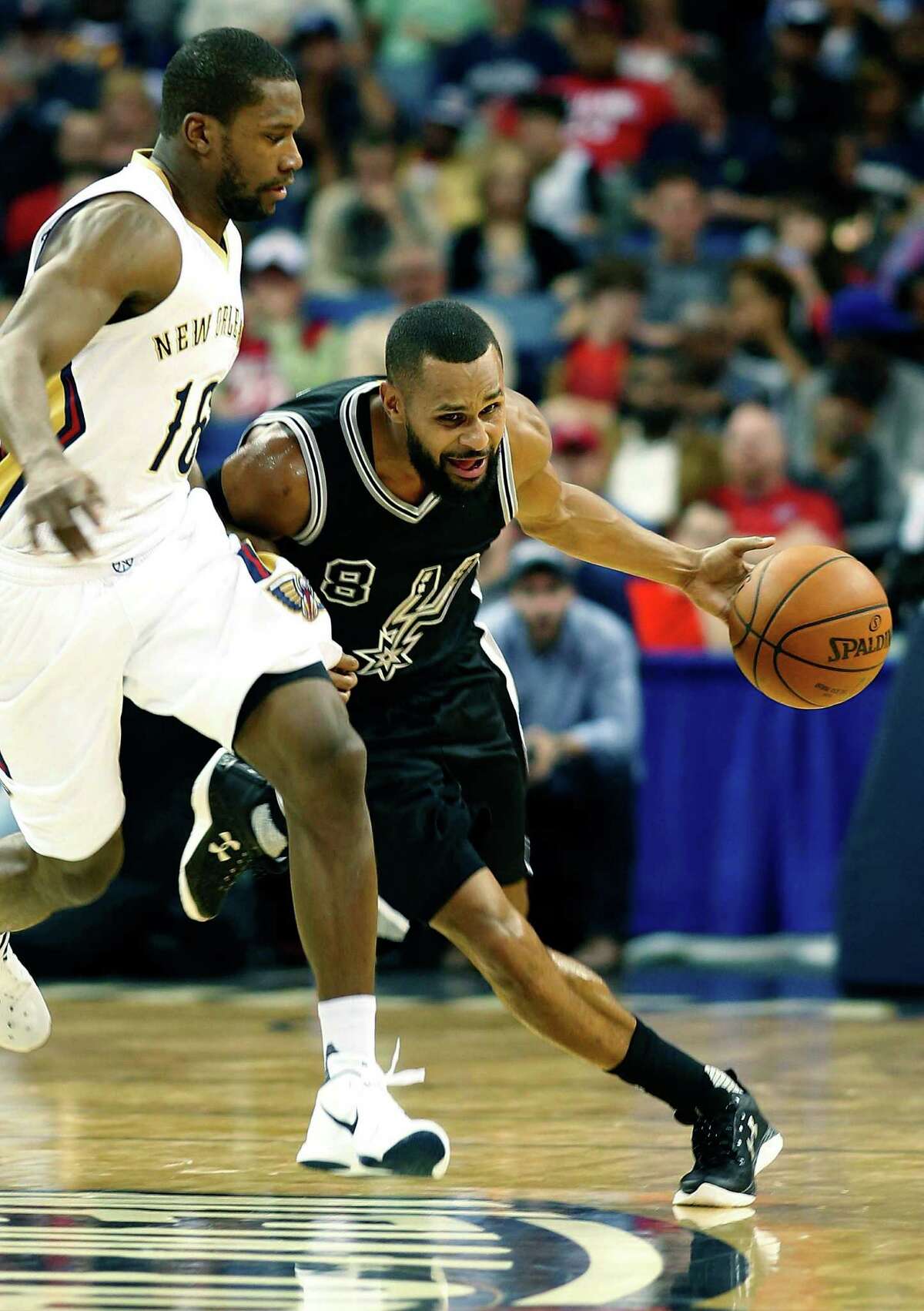 Spurs guard Patty Mills drives past New Orleans Pelicans guard Toney Douglas, left, in the second half in New Orleans on March 3, 2016.
