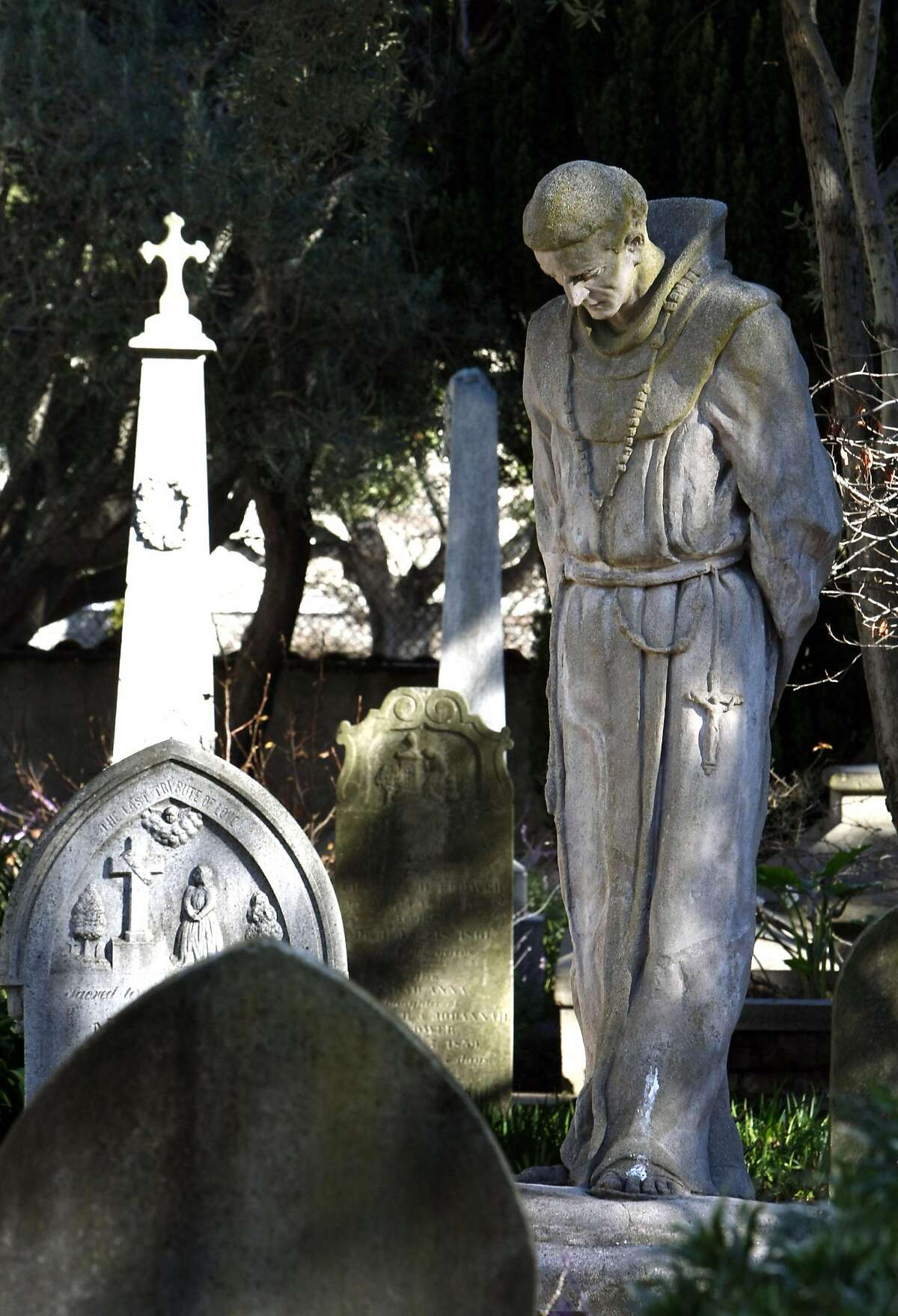 A Statue of Father Junipero Serra stands in the middle of the church cemetery at Mission Dolores in San Francisco on Tuesday, Jan 13, 2009.